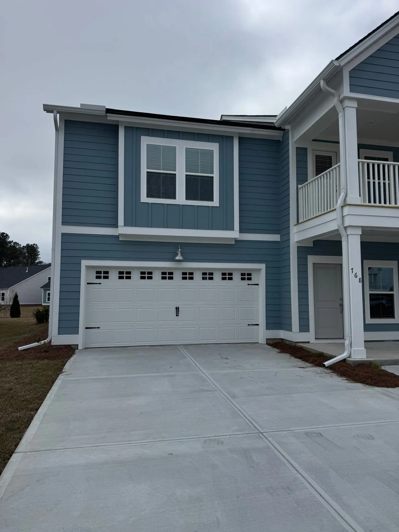 Two-story blue home with continuous white gutters
