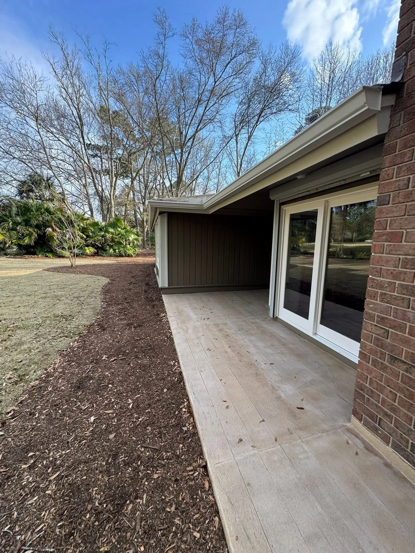 Gutter run along a covered rear porch on a brick home