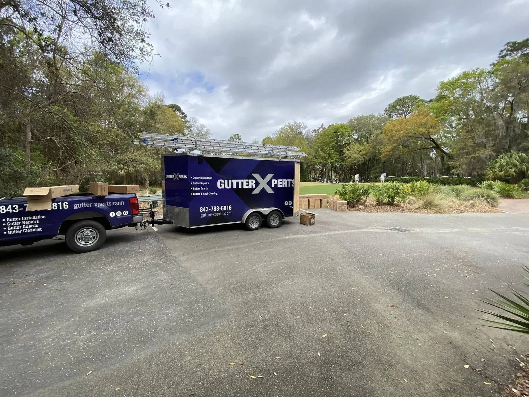 Helder's work truck and enclosed gutter trailer parked on a job